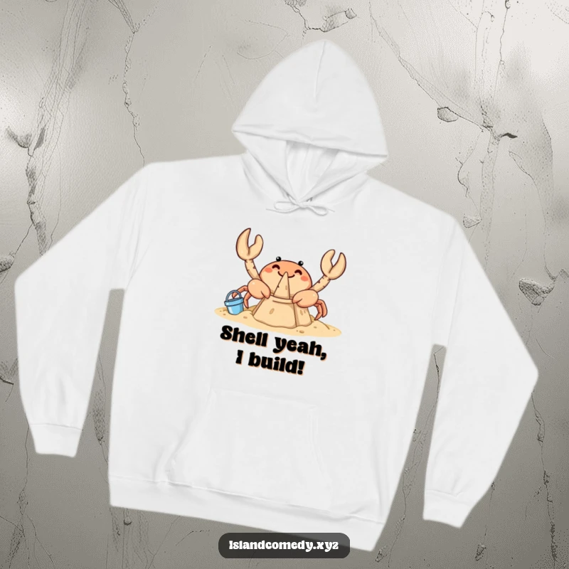Funny crab hoodie illustration of a curious crab diligently building a sandcastle with small buckets on a beach.